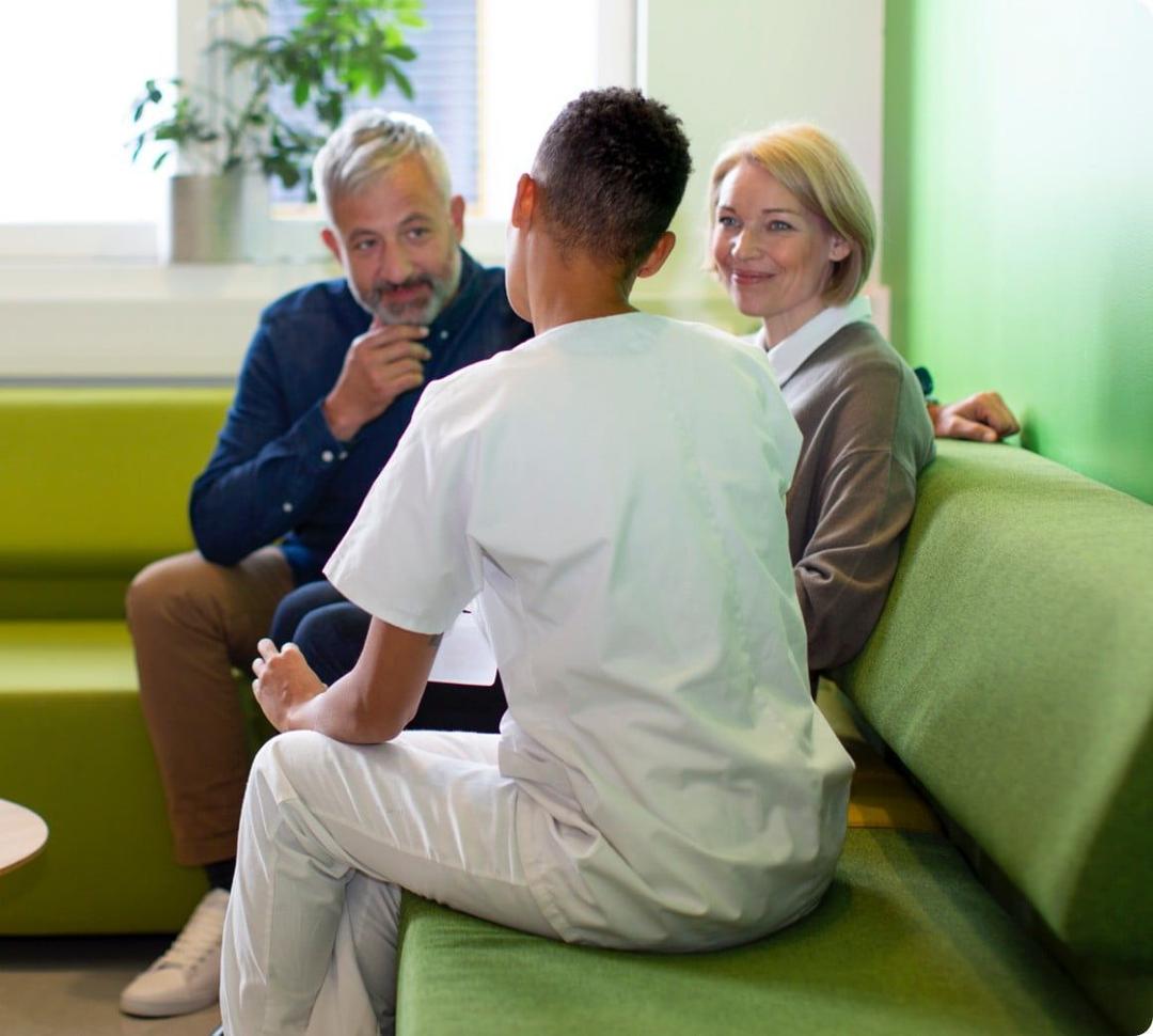 Healthcare professional talking to patient and partner